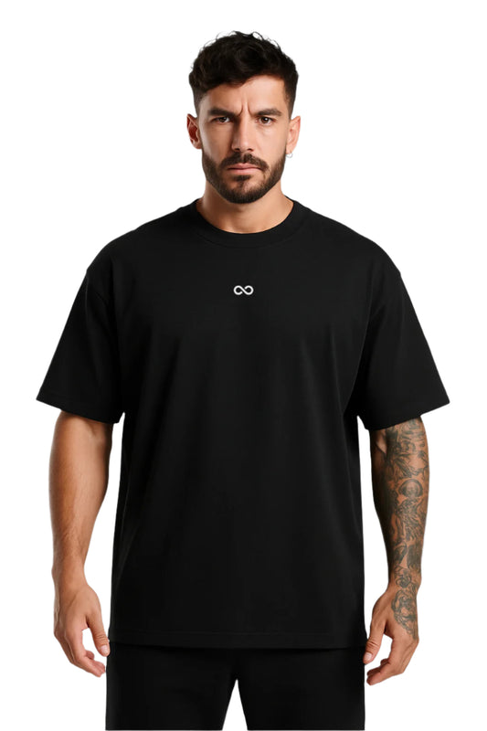 Man wearing a black t-shirt with an infinity logo on a white background