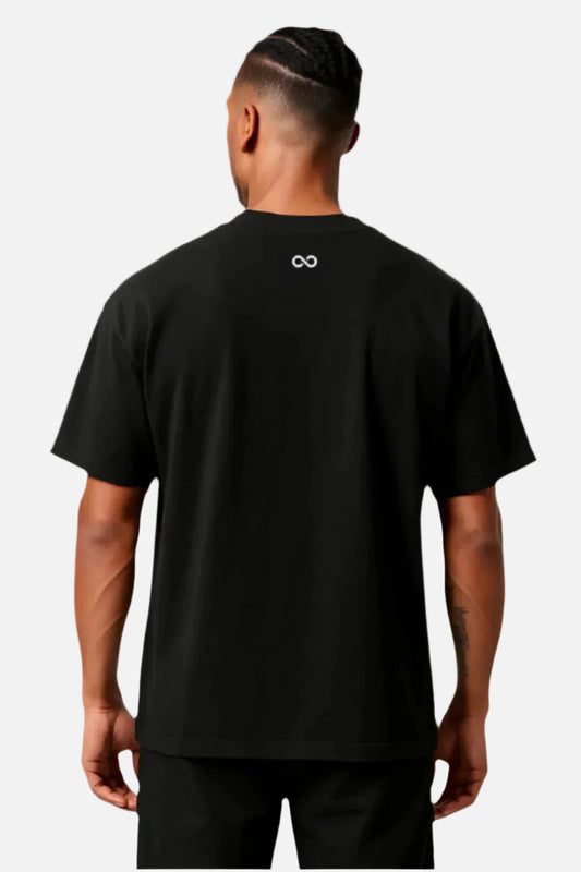 Person wearing a black t-shirt with a logo on the back against a white background