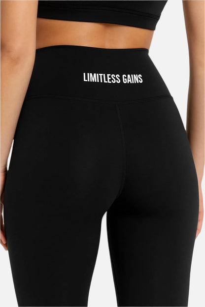 Black leggings with 'Limitless Gains' text on a white background