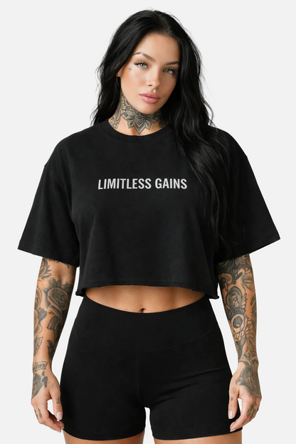 Woman wearing a black 'LIMITLESS GAINS' t-shirt on a white background