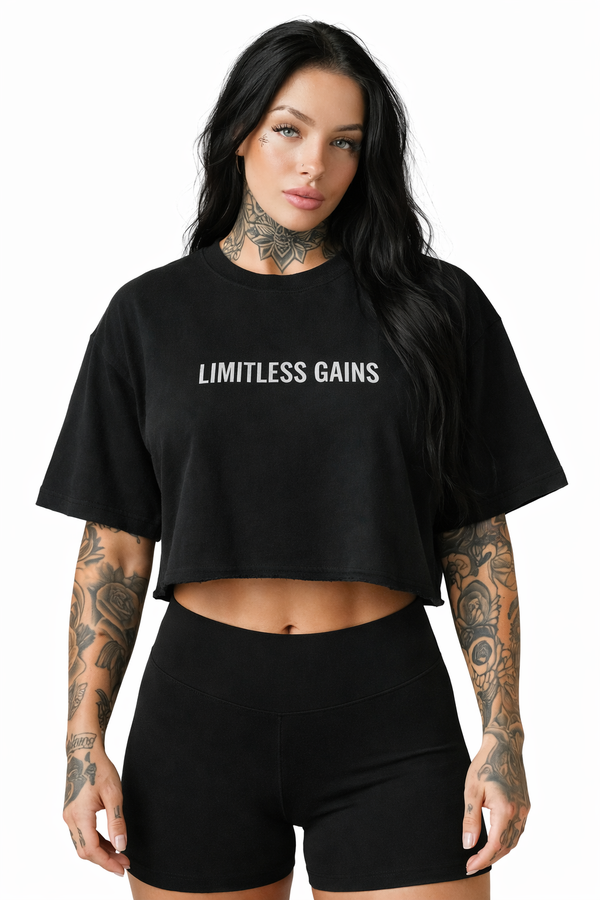Woman wearing a black 'LIMITLESS GAINS' t-shirt on a white background