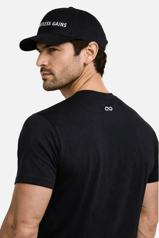 Man wearing a black cap and t-shirt with visible LIMITLESS GAINS branding on a white background