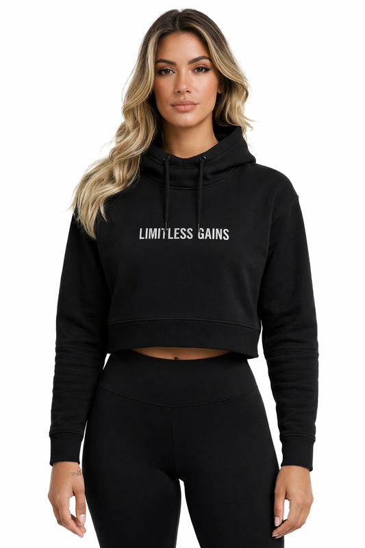 Woman wearing a black hoodie with 'Limitless Gains' text on a white background