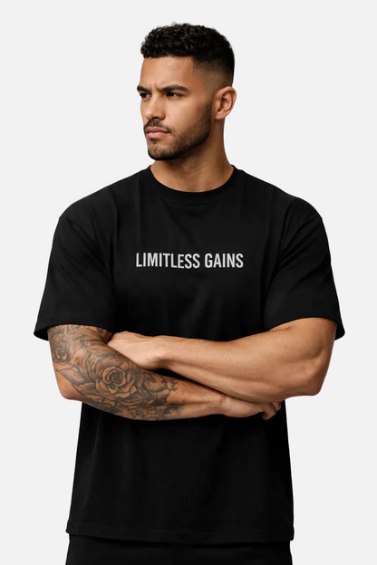 Man wearing a black t-shirt with 'LIMITLESS GAINS' text on a white background