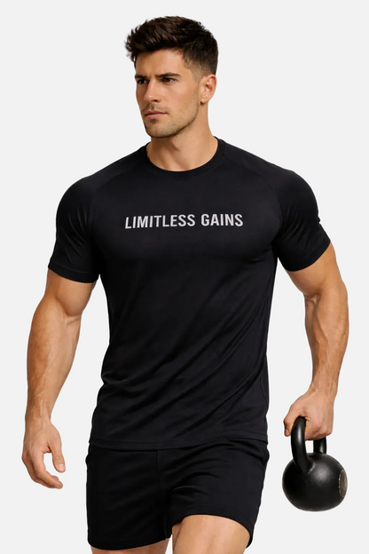 Man wearing a black 'Limitless Gains' t-shirt holding a kettlebell on a white background