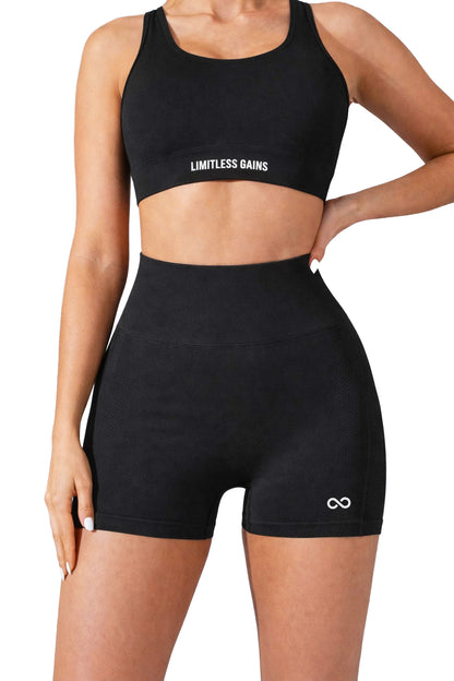 Black sports bra and shorts set with 'Limitless Gains' branding on a white background
