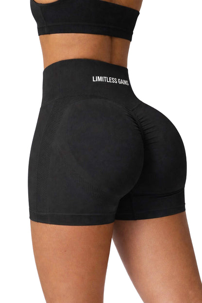 Black athletic shorts with 'Limitless GAINS' branding on a white background