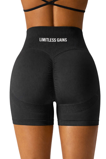 Black athletic shorts with 'Limitless Gains' branding on a white background