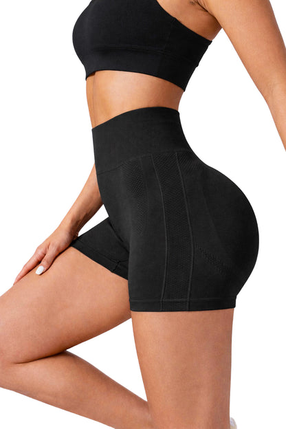 Person wearing black LIMITLESS GAINS athletic shorts and top on a white background
