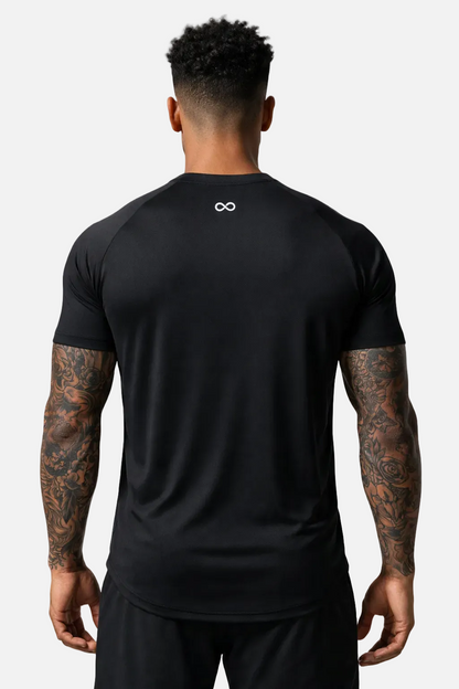 Person wearing a black athletic LIMITLESS GAINS shirt with a logo on the back, standing against a white background