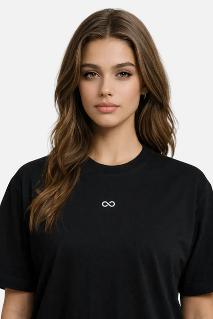 Woman wearing a black t-shirt with a white logo on a white background