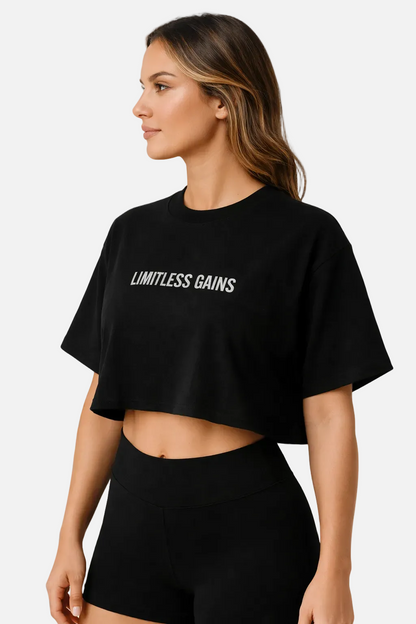 Woman wearing a black 'Limitless Gains' t-shirt on a white background