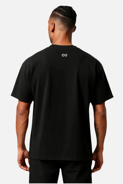 Person wearing a black t-shirt with a logo on the back against a white background