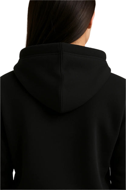 Person wearing a black hoodie with a plain background